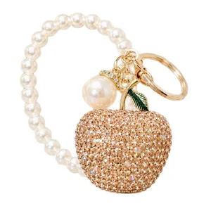 Luxury rhinestone apple pearl keychain charm, stylish phone and bag accessory pendant for women.