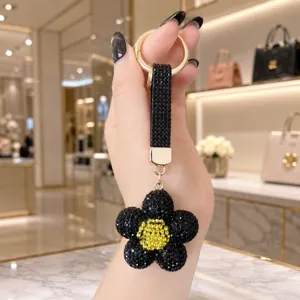 Rhinestone sunflower keychain black crystal daisy bag charm luxury gold hardware detail
