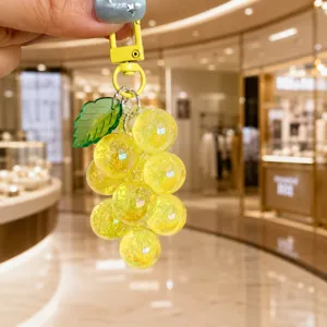 Transparent acrylic grape cluster keychain close-up view showing glossy fruit beads and cute leaf charm.