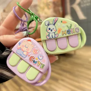 Detailed view of cute cartoon piano keychain press toy, colorful portable bag pendant accessory.