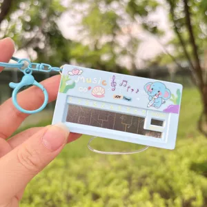 Pocket electronic piano keychain detail, cute cartoon elephant design, fun music toy pendant.