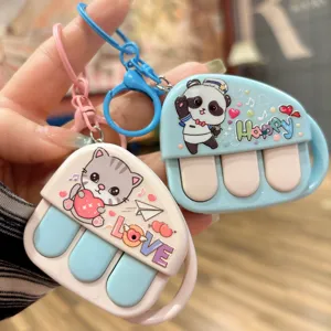 Cute music piano keychain detail, stress relief toy and lovely bag pendant accessory.
