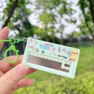 Mini electronic piano keychain detail view, cute duck pattern and music notes, portable toy design.