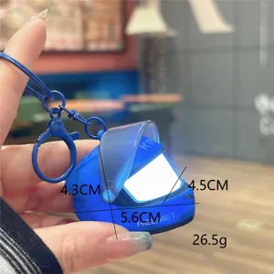Mini motorcycle helmet keychain with LED light, creative glowing bag pendant and car accessory.
