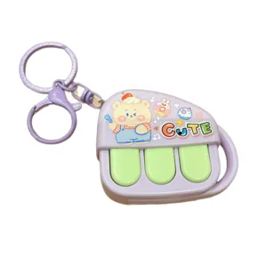 Cute piano music keychain with mini bear pendant, purple decompression toy bag charm for students.