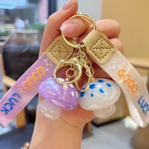 Cute jelly mushroom keychain with resin pendant and ribbon strap for stylish bags.