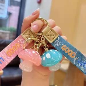 Cute jelly resin mushroom keychain with ribbon strap, stylish accessory for keys and bags.