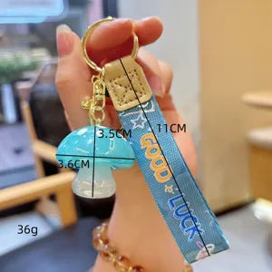 Cute blue resin mushroom keychain with woven strap, durable metal ring, perfect accessory for bags.