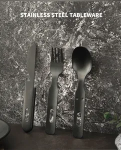 Black stainless steel tableware set with bottle opener, fork and spoon for outdoor dining.