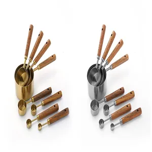 Stainless steel measuring cups and spoons set with wooden handles for baking cooking.