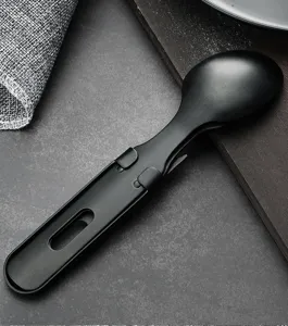 Detail view of the black multi-functional spoon featuring a built-in bottle opener tool.