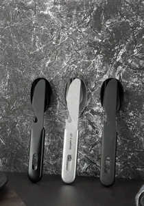 Detail view of portable outdoor titanium-plated cutlery set, knife fork spoon with opener.