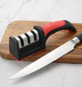 Kitchen knife sharpener with three slots and ergonomic handle on a wooden cutting board.