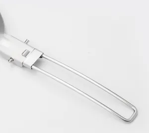 Stainless steel folding spatula handle detail close up for outdoor camping cooking gear