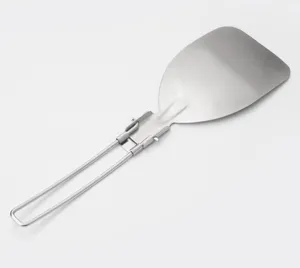 Detail shot of stainless steel foldable spatula, portable outdoor camping cooking utensil.