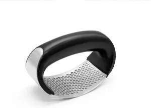 Stainless steel rocker garlic press detail, ergonomic black handle, kitchen cooking tool.