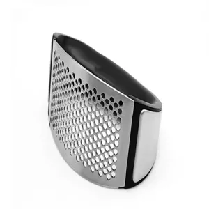 Stainless steel garlic press detail view, curved manual kitchen tool with micro holes.