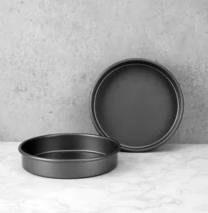 Detail view of durable round baking pans for delicious cakes and pizza in home ovens.