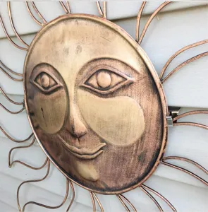 Metal sun wall art sculpture with smiling face, vintage bronze finish outdoor hanging decor.