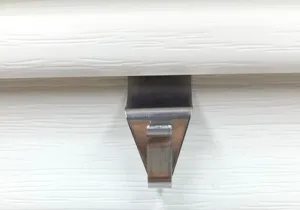 Stainless steel siding hook, detailed close-up view of vinyl siding hanger for wall mount.