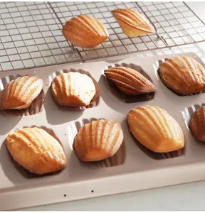 Detail view of carbon steel non-stick 12-cavity madeleine cake baking pan tray with shells