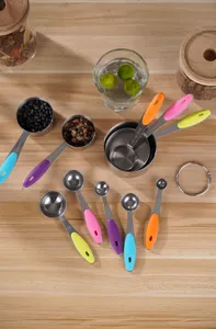 Stainless steel measuring spoons set with colorful silicone handles, kitchen baking tools detail.