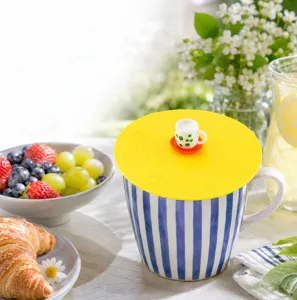 Yellow silicone cup lid with cute mini teacup handle, universal cover for ceramic mugs.