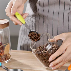 Stainless steel measuring spoons set with colorful handles for baking, coffee, and cooking.