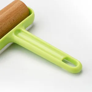 Mattarello in legno con manico verde per cottura, ideale strumento da cucina per pasta.