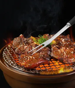 Stainless steel barbecue meat fork detail view for outdoor camping grilling and cooking sessions.