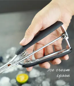Detail view of stainless steel ice cream scoop handle, spring mechanism and comfortable grip.