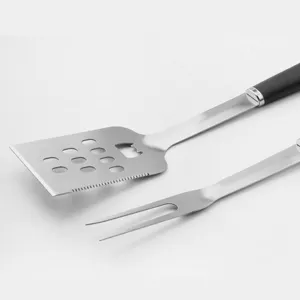 Stainless steel BBQ grill tool set featuring spatula and fork for outdoor camping cooking.
