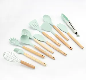 12-piece mint green silicone kitchen utensil set with wooden handles for non-stick cookware