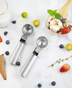 Stainless steel ice cream scoop detail, spring trigger design for easy serving, durable kitchen tool.