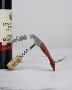 Close-up detail of the stainless steel and wooden handle wine corkscrew in action.