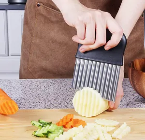 Detail view of crinkle cutter stainless steel wavy knife for cutting potatoes and vegetables.