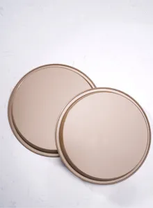 Close-up of golden round non-stick pizza baking pan tray for kitchen pastry and cake making.
