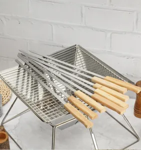 Stainless steel barbecue skewers with wooden handles detail shot, perfect for outdoor grilling.