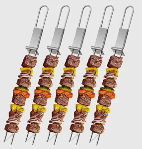 Detail view of stainless steel BBQ skewers close up showing meat and vegetable arrangement.