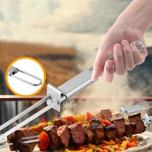 Stainless steel BBQ skewer grilling fork with sliding push mechanism for outdoor barbecue cooking.