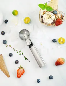 Stainless steel ice cream scoop detail view, kitchen tool for making round balls.