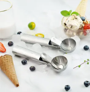 Stainless steel ice cream scoop detail view, showing spring trigger and polished bowl.