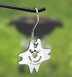 Stainless steel metal grill scraper cleaning tool detail hanging on hook outdoor setup
