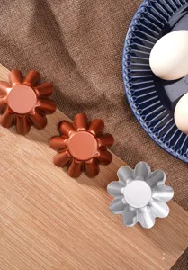 Detailed view of flower shaped baking mold, ideal for homemade egg tarts and mini cakes.