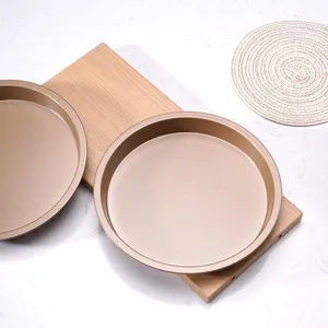Gold round non-stick pizza baking pan and cake mold set for professional kitchen baking use.
