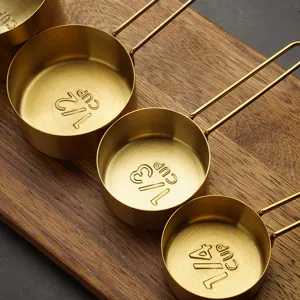 Stainless steel gold plated measuring cups set main view kitchen baking tools presentation.
