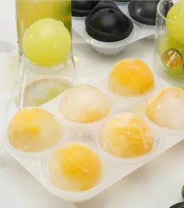 Silicone ice ball mold detail view, clear spheres inside transparent tray for cold drinks.