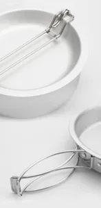 Aluminum camping pot detail shot showing portable folding handle and pure metal texture.