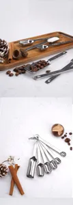 Stainless steel measuring spoons set with clear capacity scales for baking and coffee.