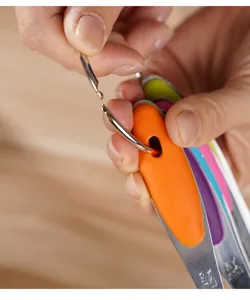 Stainless steel measuring spoons set with colorful silicone handles for kitchen baking cooking.